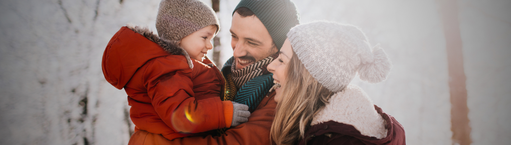 Family Smiling at Each Other in a Snowy Landscape