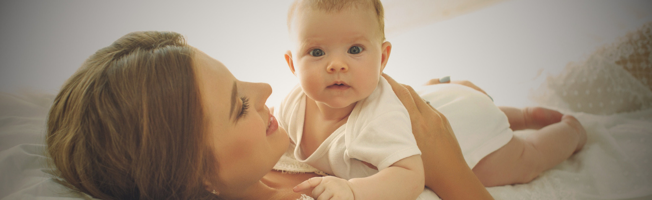 Mother smiling holding her baby