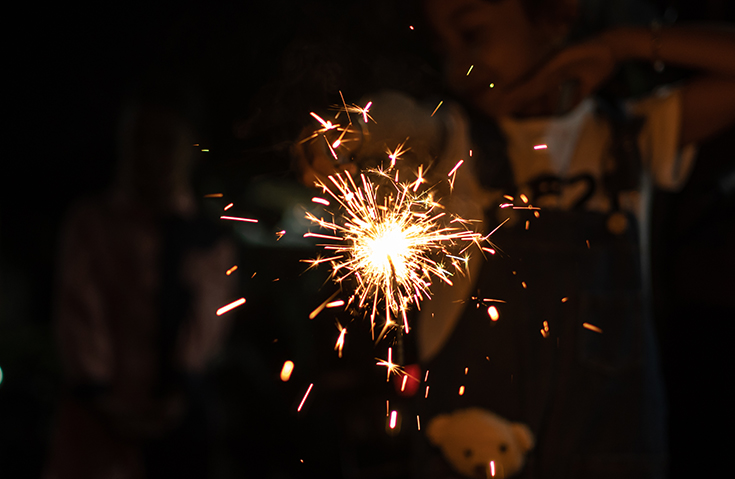 Child holding a sparkler firework