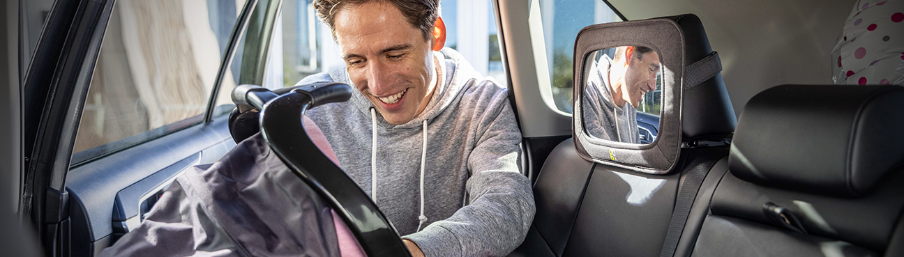 Father Smiling At Baby In Car Seat